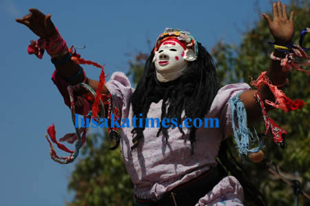 A female nyau dancer showcasing her talent during the Kulamba