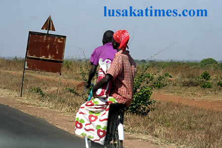 Transport by bicycle is common in Nyimba. Here a husband ferrying his wife on two wheels