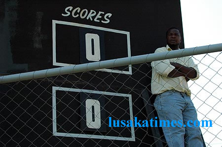 A scoreboard attendant waiting for Zanaco and Forest Rangers players' to score for him to show the tallies on his board