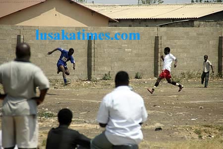 Some residents of Kanyama township watching a social football game dubbed 'Kick AIDS out'