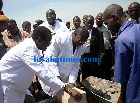 George Kunda and Chambeshi Board Chairman Mpundu Shapi Lay a foundation brick at the ground breaking ceremony of a 9 billion water project at Kapoka village in Kasama