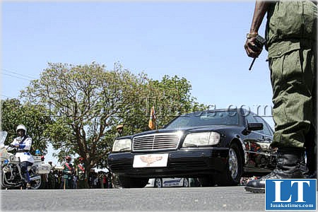A presidential guard stands beside President banda's Mercedes Benz car