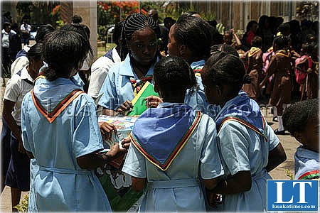 Children from different schools share educational materials after receiving the literature from the Girl Guides Association of Zambia
