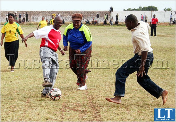 ACTING Assistant Secretary Anthony Mutono controls the ball as he is challenged by Acting Provincial Information Officer Himweela Mooya (r)during Independence Day celebrations at Kasama Sports stadium