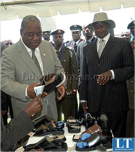 President Banda and his Ugandan counterpart Yoweri Museveni inspect hand made shoes on the sideline of the african Union summit in Kampala, Uganda