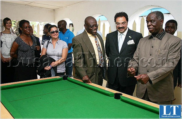 Presidential Affairs Minister Ronald Mukuma (r) talks to Barclays Bank managing director Zafar Masud, an International Labour Organization youth Representative and Luapula Province Permanent Secretary