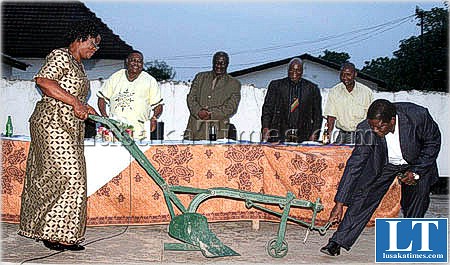 Retired Western Province Deputy Permanent Secretary Phanuel Chibala and his wife inspect an ox driven plough presented to them during a farewell party in Mongu.