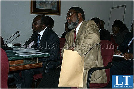 ZRA Commissioner general Criticals Mwansa folking out some documents from and envelope when he appeared before the parliamentary committee on estimates