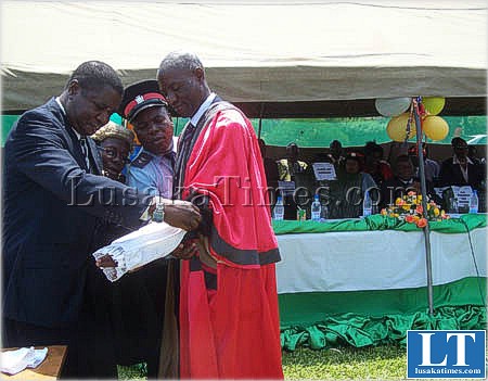central province minister Ackimson Banda dresses Kabwe mayor Chimbwi Musonda after he was elected