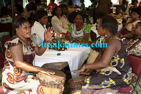 Women beating drums during a kitchen party at Arakan Barracks in Lusaka