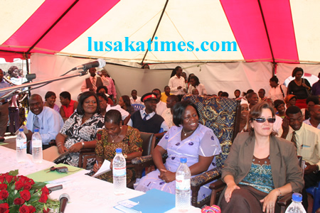 (From left to right)Lusaka District Commissioner, Christah Kalulu,Chawama area member of Parliament,Bredt Sampa Deputy director of epidemiology and diseases control,Dr Bushimbwa Tambatamba and UNICEF deputy country represantative, Elspeth Erickson watching a sketch(not in picture) during the Lusaka district risk reduction sensitisation programme at Chawama basic school programmes