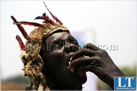 A dancer replenishes his energy with a local tuber after a an energetic dance