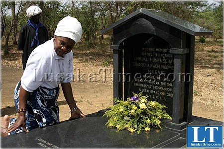 Chieftainess Nkomeshya lays a wreath on the grave of one of the Soli ancestors