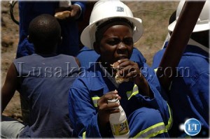 A pupil from Luanshya Copper Mines on the business end of a rock ban and Maheu food drink after an energetic performance during the re-opening of Luanshya Copper mines. Zambia Dec 2009 A pupil from Luanshya Copper Mines on the business end of a rock ban and Maheu food drink after an energetic performance during the re-opening of Luanshya Copper mines. Zambia Dec 2009