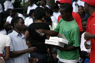 An unidentified youth distributing comdoms during the World Aids day event in Lusaka