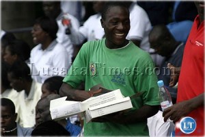 Free condoms..save your life...an unidentified man distributes condoms during the World AIDS day celebration in Lusaka