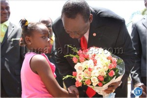 Shikapwasha receives flowers from Christine Muteba on arrival at Burning Bush Ministries where he opened a conference in Lusaka, Dec 27th