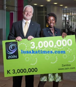 Zain Zambia Managing David Holliday hands over the K3 million scratch card to the winner 18year old Edna Mwamba 