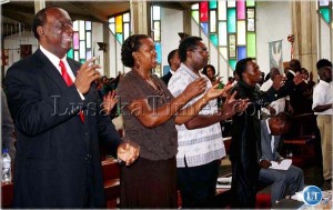 Information and Broadcasting Services Minister Ronnie Shikapwasha, Heritage Party leader Brigadier General Godfrey Miyanda and his wife Angela and the clergy sing hymns at the commemoration of the 18th anniversary of the declaration of Zambia as a Christian Nation at the Anglican Cathedral of the Holy Cross in Lusaka recently.