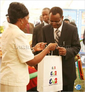 Vice president george Kunda receives a gift from ZNBC acting managing director Juliana Mwila during the launch of TV2 in Lusaka