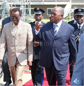 President Rupiah Banda talks to Vice President George Kunda before he left for Angola at Lusaka International Airport yesterday.