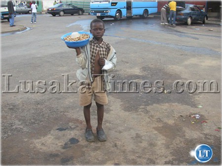 A five year old boy selling groundnuts at Mwaiseni bus station in Chingola.
