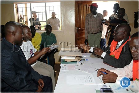 Milanzi Parliamentary by-election Returning Officer Mukiti Lukonga, talks to MMD campaign manager Dr. Eustarckio Kazonga and candidate, Whiteson Banda during the filing of nominations