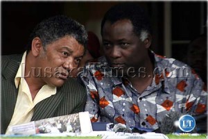 PF spokesperson Given Lubinda confers with UPND vice president Richard Kapita during a press briefing in Lusaka