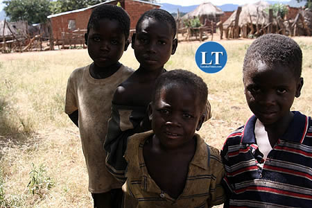Some village boys pose for a photograph in Milanzi