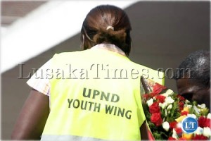 A female youth member of the UPND tries to give flowers to Hichilema at Lusaka international airport