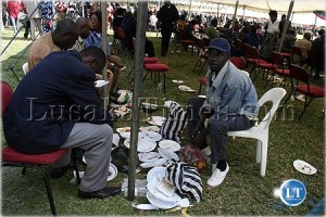 Some people pack left over food at the Africa Freedom Day celebrations in Lusaka