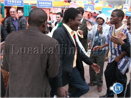 Zambian students in Russian dancing in front of their exhibition stand in order to attract more people to see what they at the stand