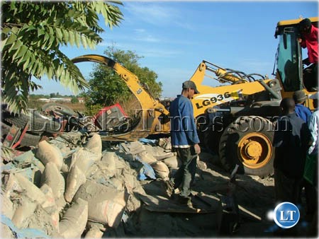 A trucker stands helpless after he flipped the vehicle was using to transport cement