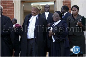 Lawyer Irene Kunda wife of George Kunda and professor Patrick Mvunga at the funeral of the late Judge Peter Chitengi in Lusaka