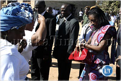Mrs Thandiwe Banda forking her hand bag to get money to award dancing MMD cadres in Mutendere township