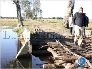 Western Province Permanent Secretary Seth Muleya walking at the damaged bridge in Kalabo during his familiarization tour in Kalabo