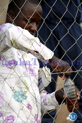 An_unidentified_youth_mixing_an_ilicit_drink_before_the_FAZ-KCM_games_at_Nkoloma_stadium_in_Lusaka