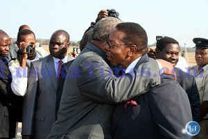 President Rupiah Banda embraces his Malawian counterpart Mbingu Wa Mutarika at Lusaka international airport