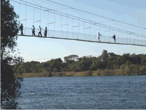 Local residents crossing the Suspension Bridge over the Zambezi River in Zambezi district-Courtesy of Grace