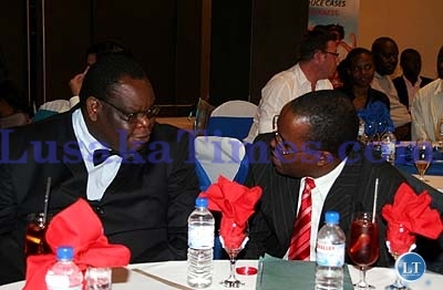 Lusaka province minister Charles Shawa (left) talks to unilever Zambia country director Johnson Gapu during the launch of new products for Unilever in Lusaka