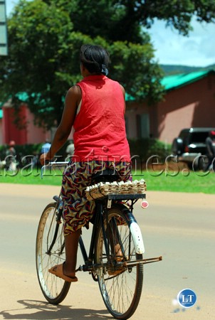 Bicycles are a major source of transport in Chipata. Here, a woman cycling along the township roads