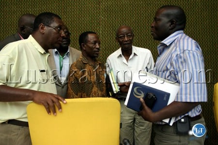 National Sports Council of Zambia officials consulting each other at the Andrew Kamanga annual general meeting in Lusaka