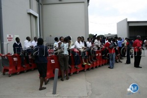 Shoprite Zambia employees perched on trolleys behind the Manda Hill staore