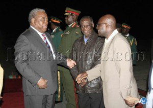 President Rupiah Banda talks to Education Deputy Minister Boniface Kawimbe as Presidential Affairs Minister Ronald Mukuma (center) looks on before he left for South Sudan at Lusaka1 International Airport