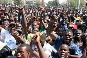 Members of the public wave the Patriotic Front symbol at the inauguration of President Michael Sata