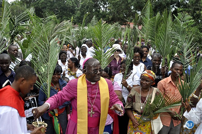 Lusaka Archbishop Telesphore Mpundu blesses christians with holy water during palm sunday celebrations