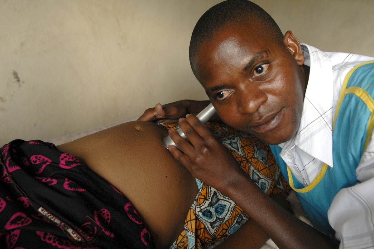 Nurse Edward Banda examines pregnant women