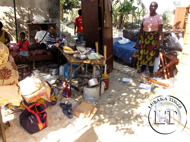 A mother and her children languishing in the open after they were evicted because their retired father was chased out of their house because of non payment of house rentals in Kitwe