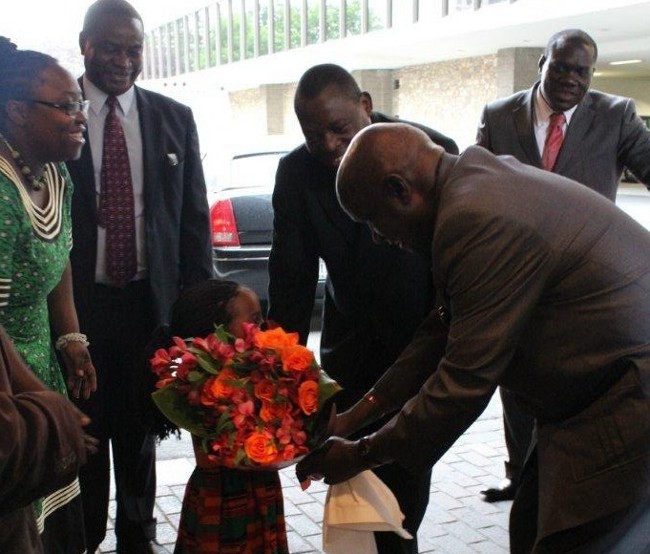 Dr Kaunda receives flowers from Nalyambai on arrival in Washington. Looking on if Charge d'affairs Mr. Ben Kangwa and First Secretary (Immigration) Mr Mahind Musonda. Dr Kaunda receives flowers from Nalyambai on arrival in Washington. Looking on if Charge d'affairs Mr. Ben Kangwa and First Secretary (Immigration) Mr Mahind Musonda.