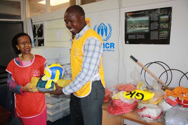 iocdonations Mr. Chileshe hands over some sports kit to UNHCR Representative in Zambia, Ms Mends-Cole
